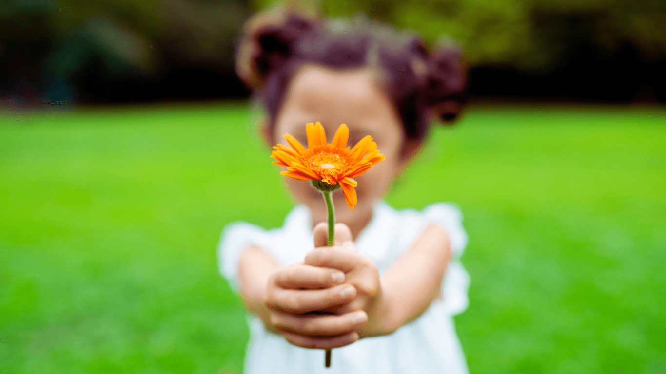 A Little Girl Showing Gratitude by Offering Flower