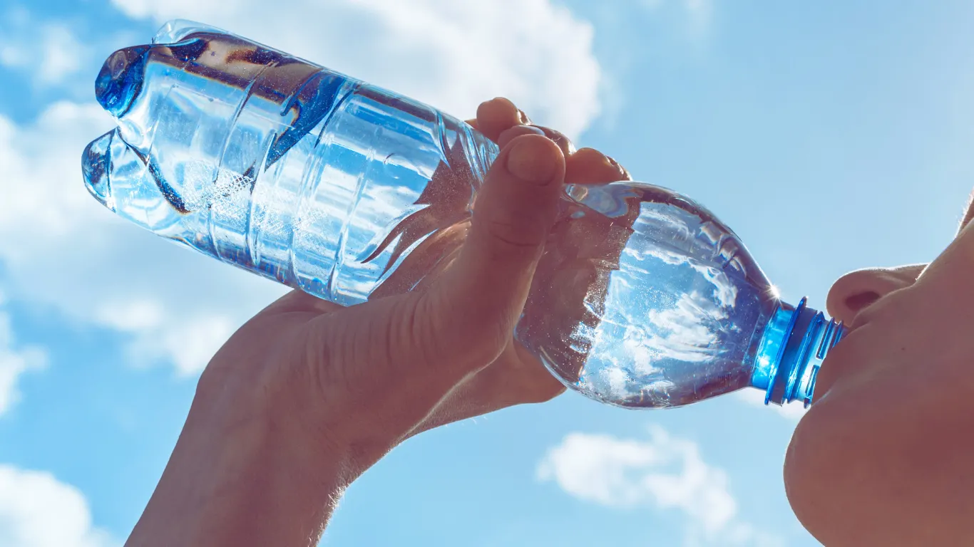 Person drinking water to maintain hydration